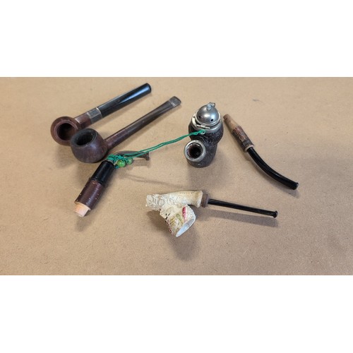 604 - Smoking memorabilia inc. two briar tobacco pipes, one novelty figural meerschaum-style pipe bowl wit... 