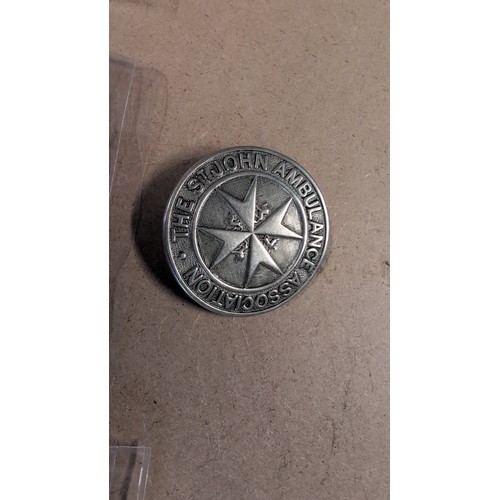 605 - St John Ambulance Association badge, enamel lapel badge ‘40 Years Service’, embroidered St John Ambu... 