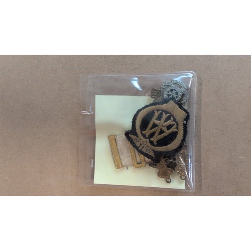 605 - St John Ambulance Association badge, enamel lapel badge ‘40 Years Service’, embroidered St John Ambu... 