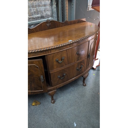 1017 - Bow-front mahogany sideboard, early 20th century, with gadrooned edge and shaped gallery, fitted wit... 