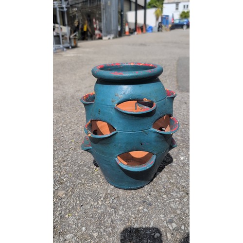 102a - A terracotta strawberry jar, turquoise-painted; the interior left unglazed, with central drainage ho... 