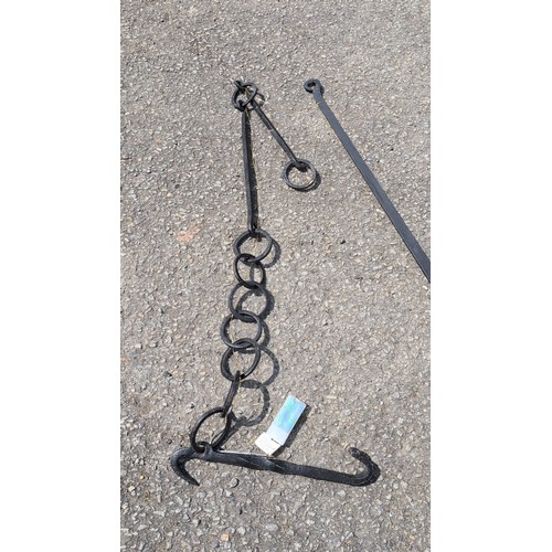 102b - Two wrought-iron hearth implements comprising a hanging pot trammel with chain and double hook, and ... 