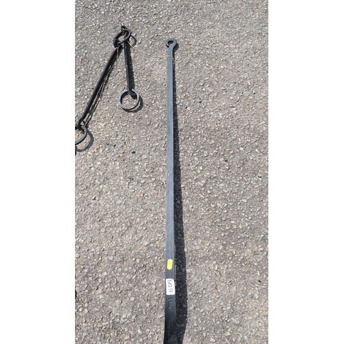 102b - Two wrought-iron hearth implements comprising a hanging pot trammel with chain and double hook, and ... 