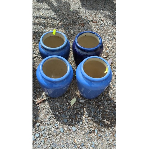 62 - A group of four glazed ceramic storage jars.