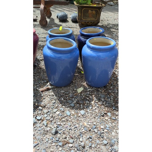 62 - A group of four glazed ceramic storage jars.
