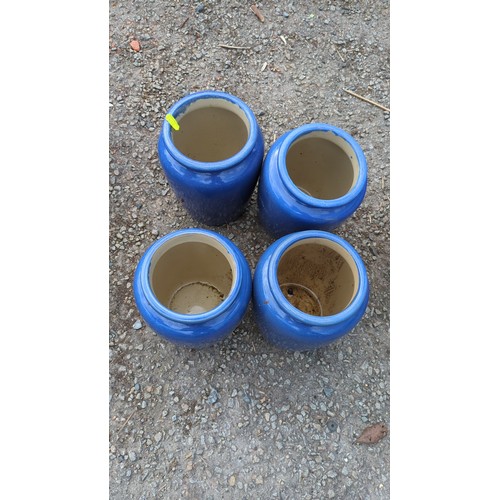 64 - A group of four glazed earthenware storage jars.