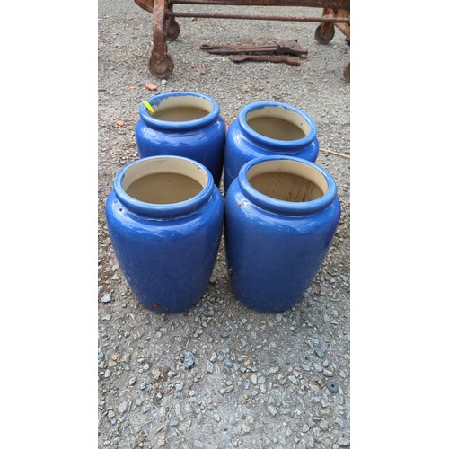 64 - A group of four glazed earthenware storage jars.