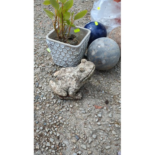 72 - A group of garden ornaments comprising a square cast composite planter, a seated frog figure, and th... 