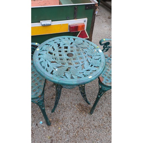 82 - A heavy cast-iron garden bistro suite.