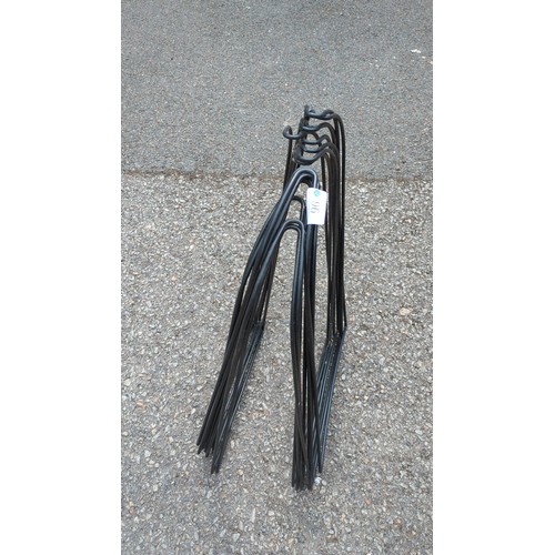 96 - A set of black painted steel garden edging hurdles.