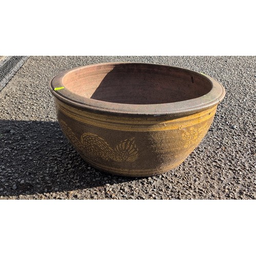 59B - Large moulded terracotta jardinière of wide circular form with thick rolled rim, painted with ochre... 