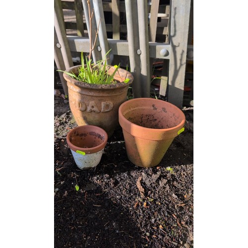 59C - A group of terracotta garden planters, including an inscribed pot reading ‘DAD’ with a rolled rim, a... 