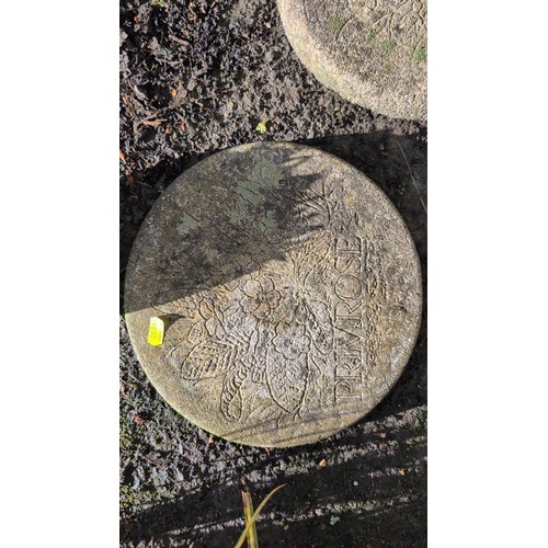 59d - A group of three cast stone garden stepping stones of circular form, each moulded in relief with flo... 