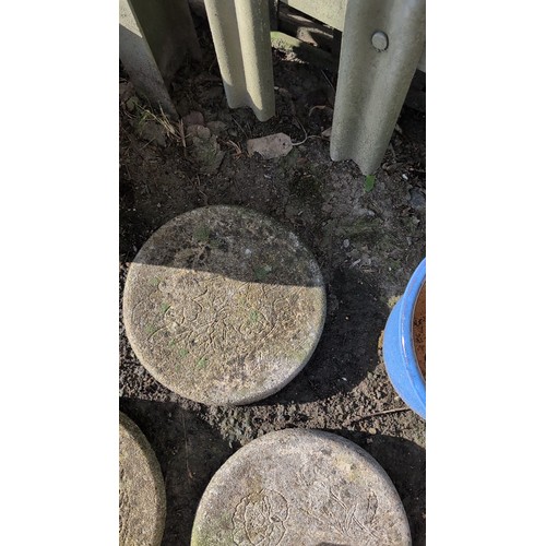 59d - A group of three cast stone garden stepping stones of circular form, each moulded in relief with flo... 