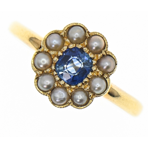 Sapphire and seed pearl cluster ring, in a yellow metal setting marked '18CT', the sapphire measuring approximately 4.5x5mm, size R1/2, gross weight 4.16 grams