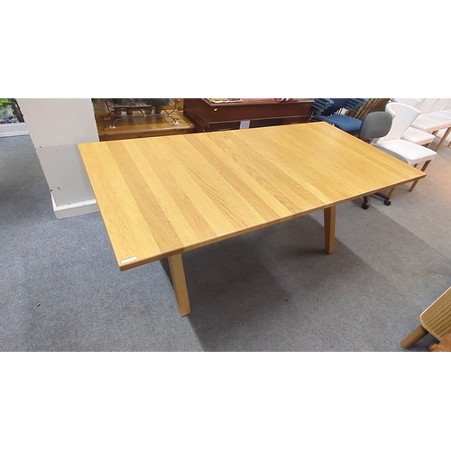 Contemporary rectangular oak dining table, the plank-effect top with chamfered edge, raised on splayed trestle supports united by stretchers; underside with metal mounting plates.