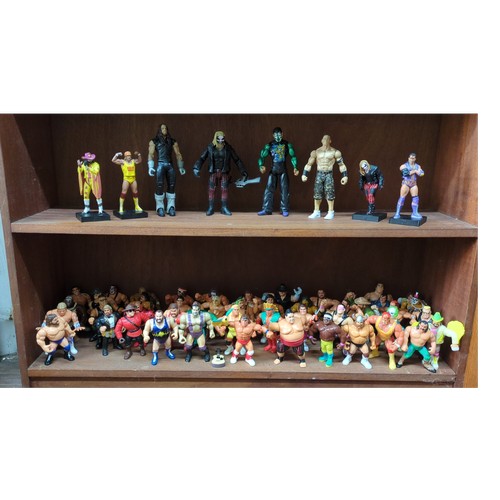 Lot 233: A group of WWF/WWE-style wrestling action figures and display models, moulded plastic, various characters and ring attire; several mounted on black plinth bases.