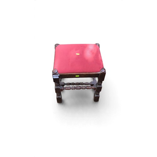 Rectangular upholstered stool with a red fabric seat, dark-stained ...