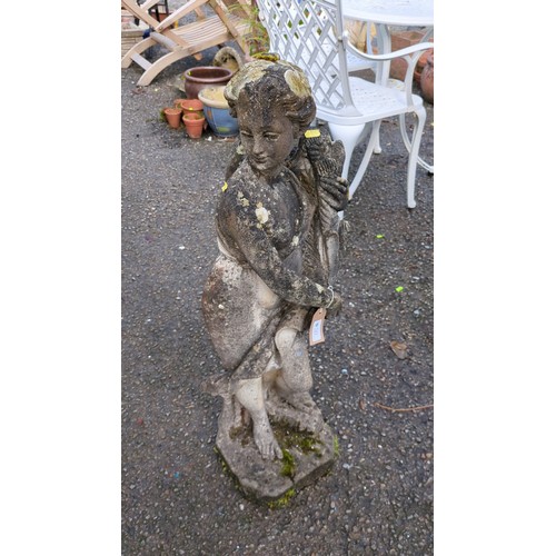 Garden figure in concrete, modelled as a robed maiden holding flowers.