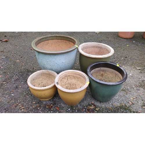 Five glazed ceramic garden planters of varying sizes, comprising a ...
