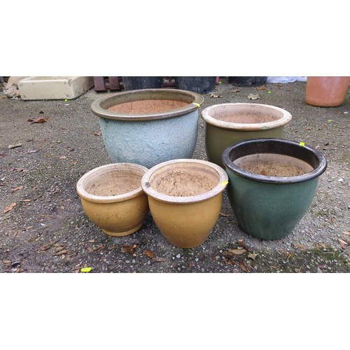 Five glazed ceramic garden planters of varying sizes, comprising a ...