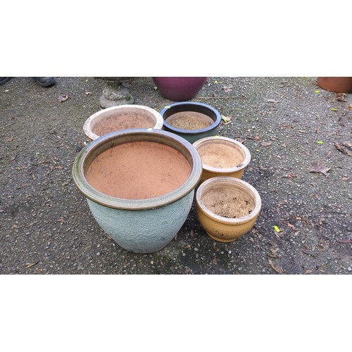 Five glazed ceramic garden planters of varying sizes, comprising a ...