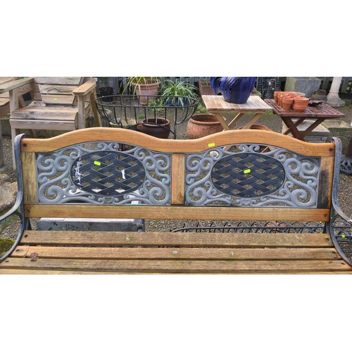 Cast-iron and timber garden bench with a slatted seat and shaped crest ...