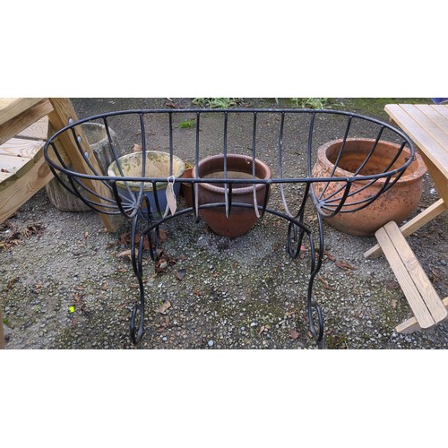 Black-painted iron garden planter of elongated oval basket form, with ...