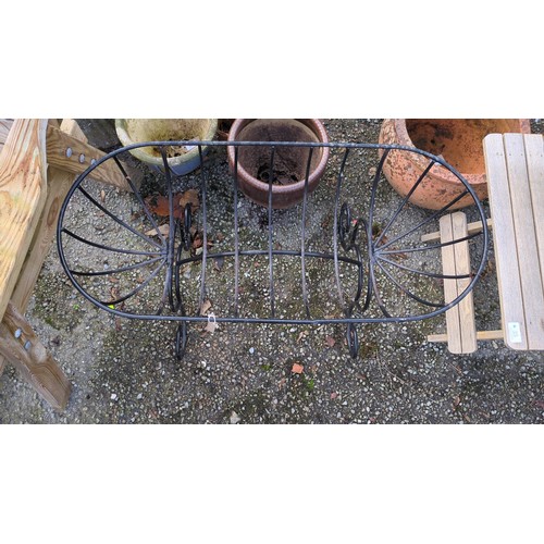 Black-painted iron garden planter of elongated oval basket form, with ...
