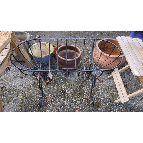 Black-painted iron garden planter of elongated oval basket form, with ...
