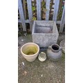 Four garden planters comprising a large square cast-stone planter, a ...