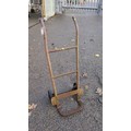 Steel sack truck with a tubular frame, curved handgrips, transverse ...