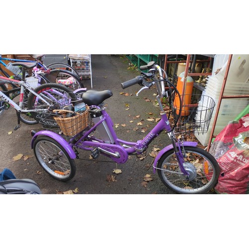 Lot 418: Jorvik folding electric tricycle in purple, with step-through frame, front hub motor, removable battery, six-speed Shimano gearing and front and rear wire baskets; accompanied by a wicker basket, charger and assembly guide.