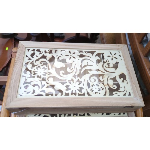 A group of four rectangular wooden storage boxes with hinged ...