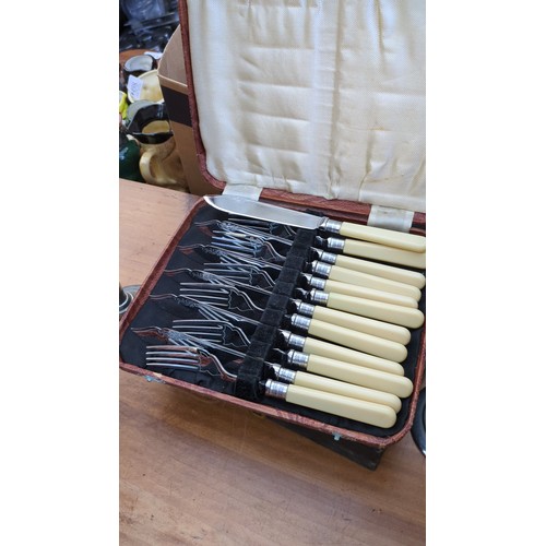 A group of cased silver-plated table and serving utensils, including ...