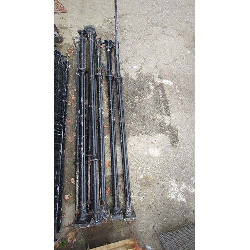 Lot 143: An assortment of cast-iron architectural railings, including baluster uprights with square plinths and a scrolling foliate corner bracket, finished in black paint; suitable for garden or period property exterior detailing.