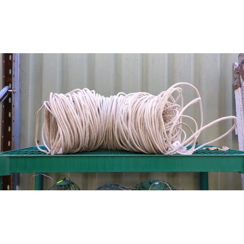 A large coil of cream-coloured, three-strand twisted rope.