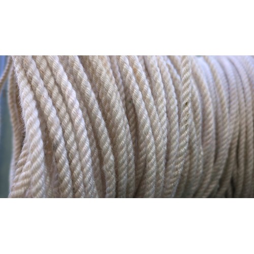 A large coil of cream-coloured, three-strand twisted rope.