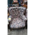 Upholstered armchair with a dark-stained timber frame, scroll-carved ...