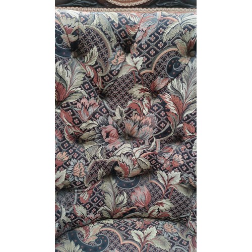 Upholstered armchair with a dark-stained timber frame, scroll-carved ...