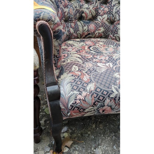 Upholstered armchair with a dark-stained timber frame, scroll-carved ...
