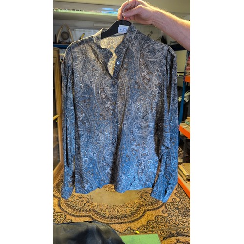 A group of garments comprising a blue paisley-print button-front shirt ...