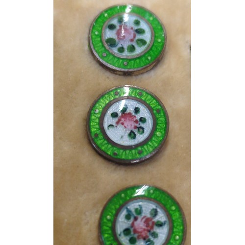 A set of six enamel dress buttons, each centred by a pink rose on a ...