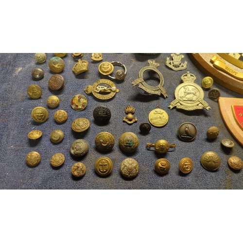 A collection of British and Commonwealth military buttons, cap badges ...