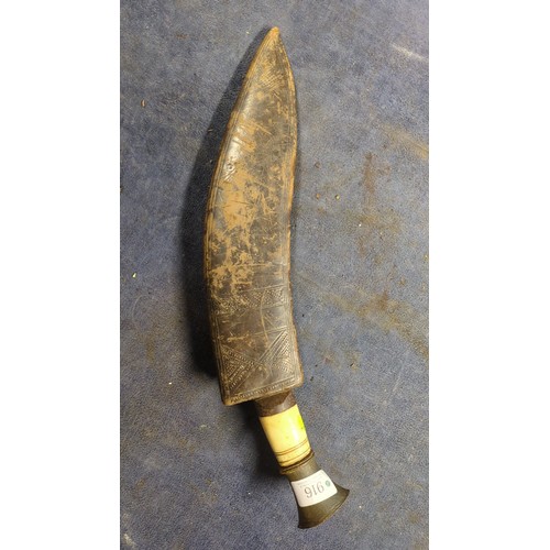 Kukri with a broad, inward-curving steel blade, pale grip and flared ...