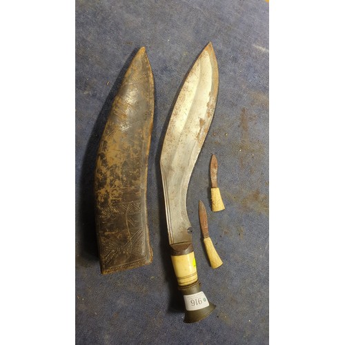 Kukri with a broad, inward-curving steel blade, pale grip and flared ...