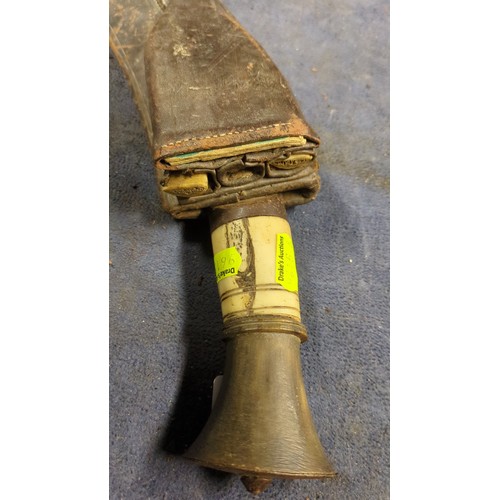 Kukri with a broad, inward-curving steel blade, pale grip and flared ...