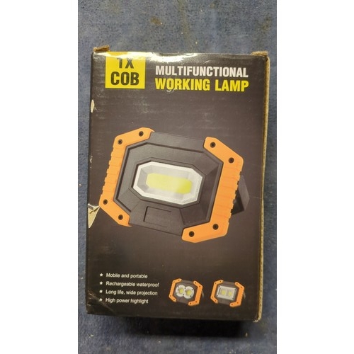 A pair of boxed multifunctional COB LED work lamps, with orange-and ...
