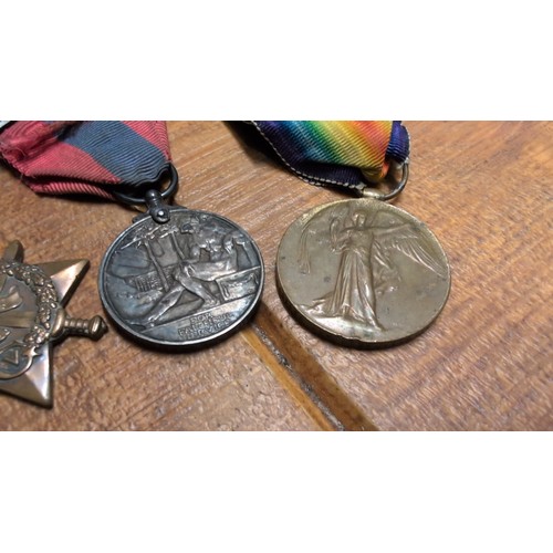 Three British medals: a 1914–15 Star, an Imperial Service Medal with ...