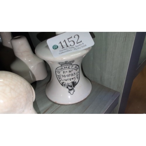A collection of glazed ceramic pie funnels of various forms, including ...